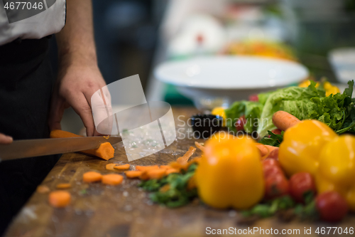 Image of chef hands cutting carrots