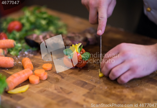 Image of closeup of Chef hands preparing beef steak