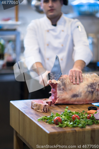 Image of chef cutting big piece of beef