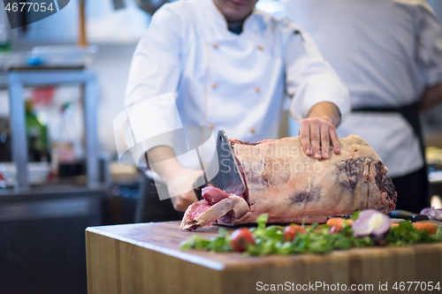 Image of chef cutting big piece of beef