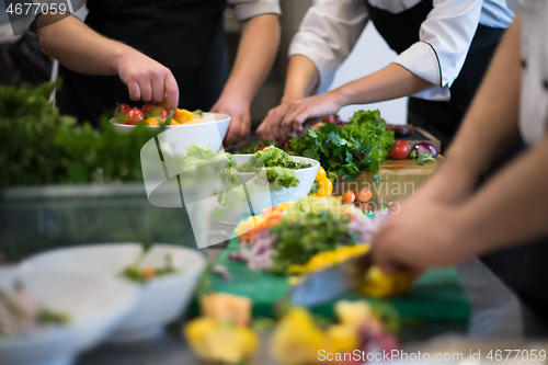 Image of team cooks and chefs preparing meals