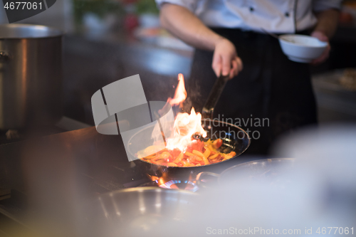 Image of Chef doing flambe on food