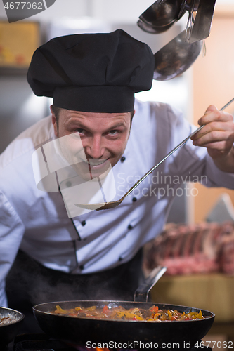 Image of chef tasting food with spoon