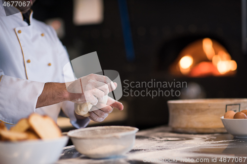 Image of chef hands preparing dough for pizza