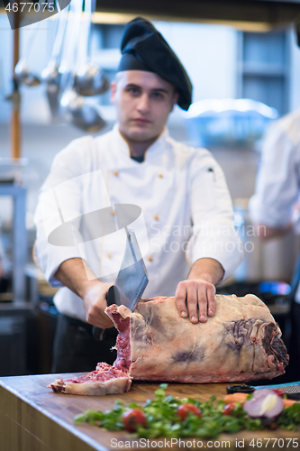 Image of chef cutting big piece of beef