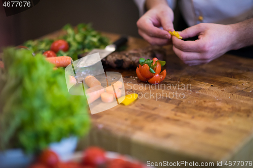Image of closeup of Chef hands preparing beef steak