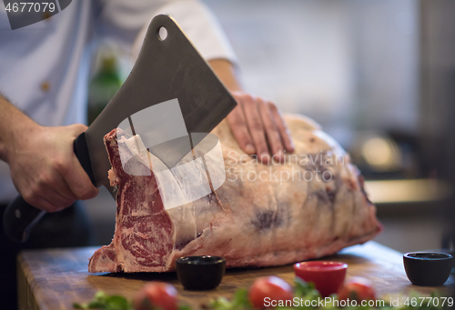 Image of chef cutting big piece of beef