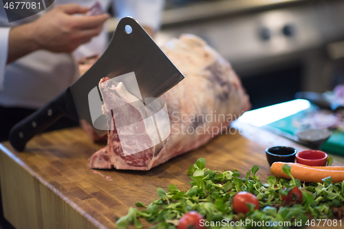 Image of chef cutting big piece of beef