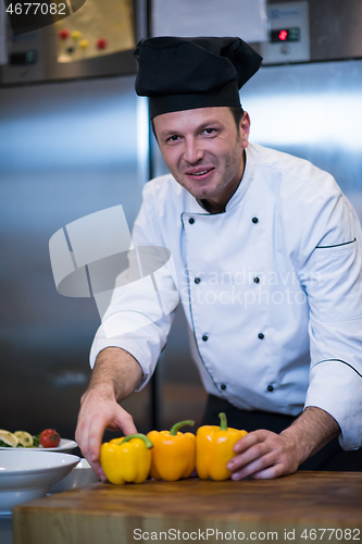 Image of chef holding fresh peppers
