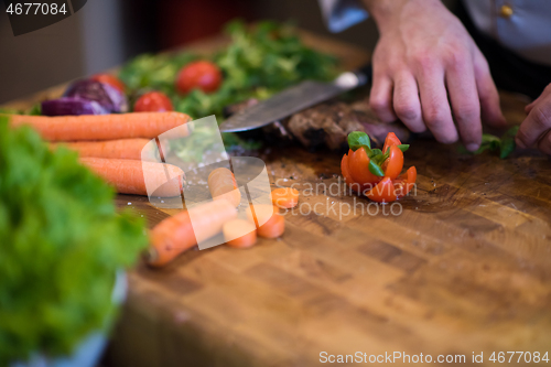 Image of closeup of Chef hands preparing beef steak