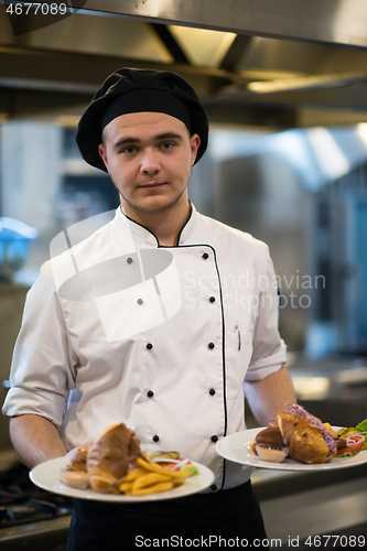 Image of Chef showing dishes of tasty meals