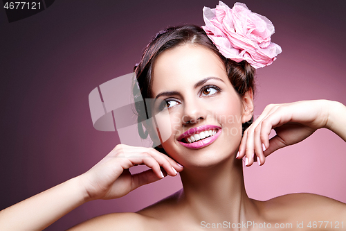 Image of beautiful girl with rose in hair