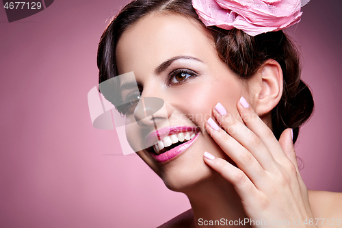 Image of beautiful girl with rose in hair