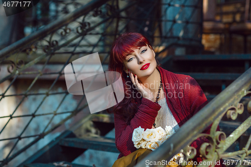 Image of Girl sitting on old house stairs