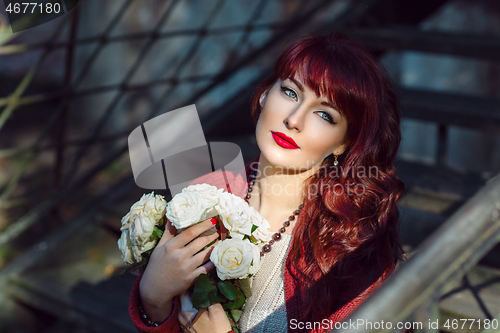 Image of Girl sitting on old house stairs