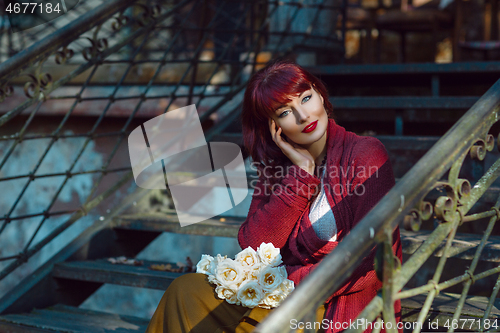 Image of Girl sitting on old house stairs