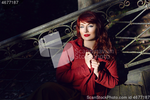 Image of Girl sitting on old house stairs