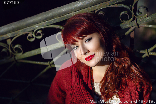 Image of Girl sitting on old house stairs