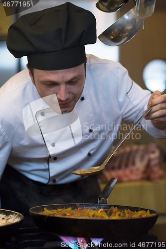 Image of chef tasting food with spoon