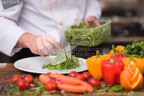 Image of chef serving vegetable salad