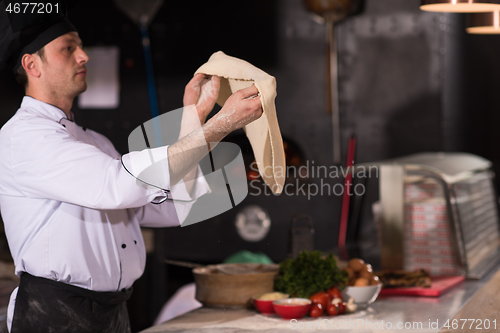 Image of chef throwing up pizza dough