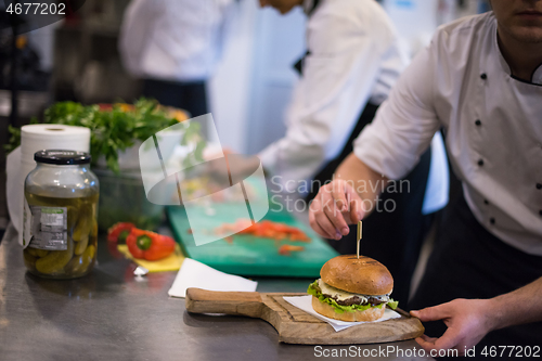 Image of chef finishing burger