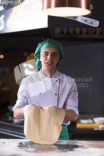 Image of chef throwing up pizza dough