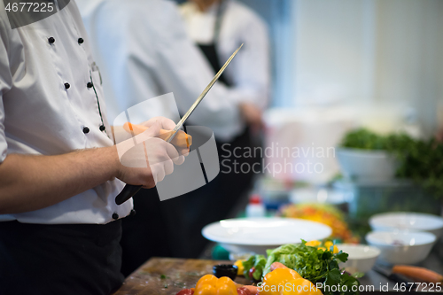 Image of chef hands cutting carrots