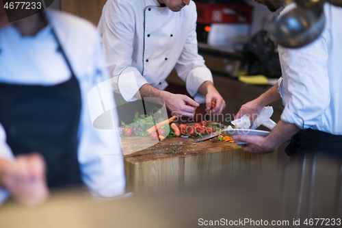 Image of team cooks and chefs preparing meal