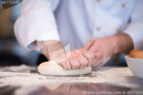 Image of chef hands preparing dough for pizza