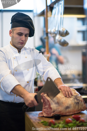 Image of chef cutting big piece of beef