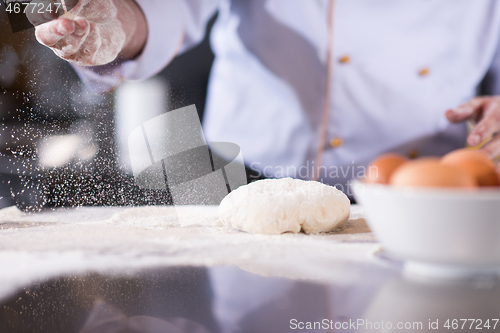 Image of chef hands preparing dough for pizza