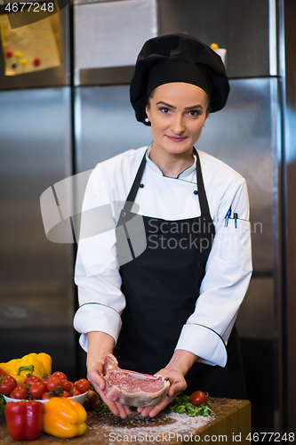 Image of Chef holding juicy slice of raw steak