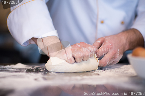 Image of chef hands preparing dough for pizza