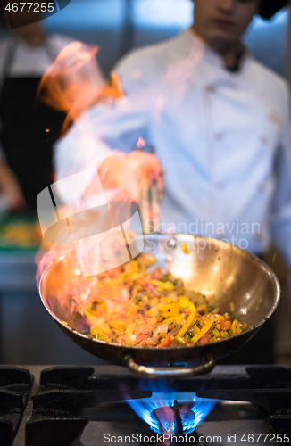 Image of Chef doing flambe on food