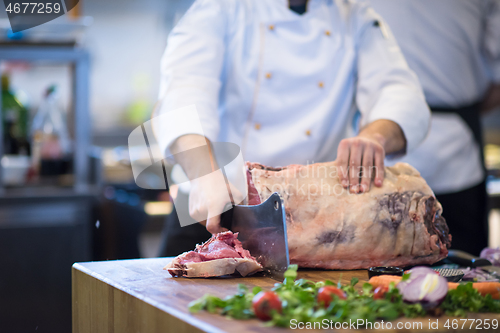 Image of chef cutting big piece of beef