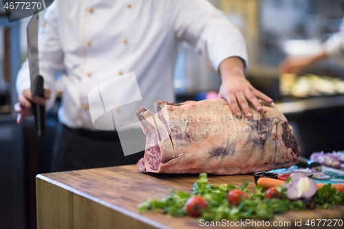 Image of chef cutting big piece of beef