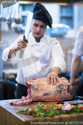 Image of chef cutting big piece of beef