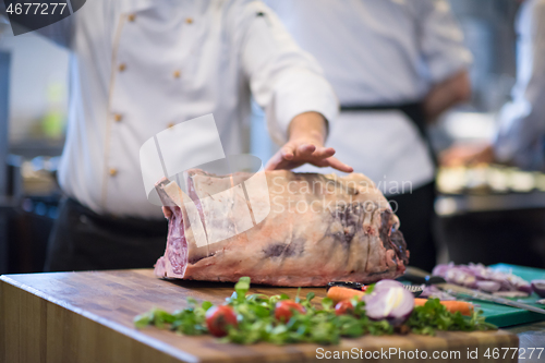 Image of chef cutting big piece of beef