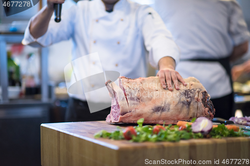 Image of chef cutting big piece of beef