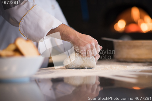 Image of chef hands preparing dough for pizza