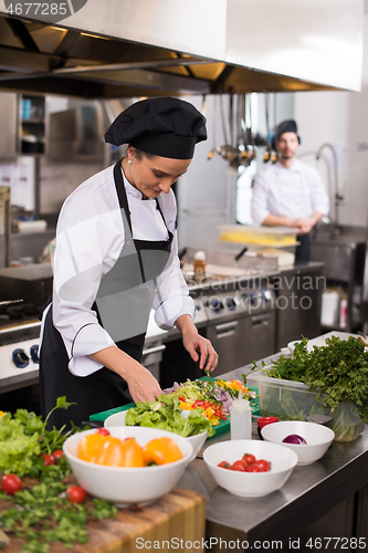 Image of chef serving vegetable salad