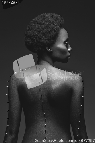 Image of Beautiful black girl with metal pins