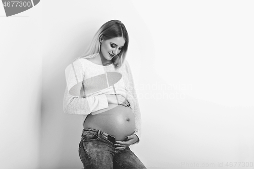 Image of Beautiful pregnant woman in jeans