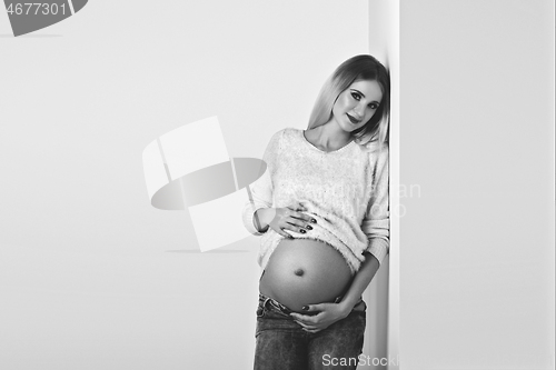 Image of Beautiful pregnant woman in jeans