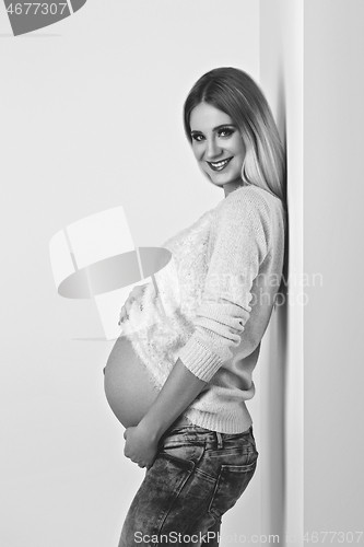 Image of Beautiful pregnant woman in jeans