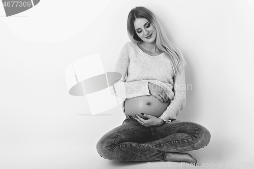 Image of Beautiful pregnant woman in jeans