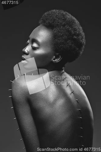 Image of Beautiful black girl with metal pins