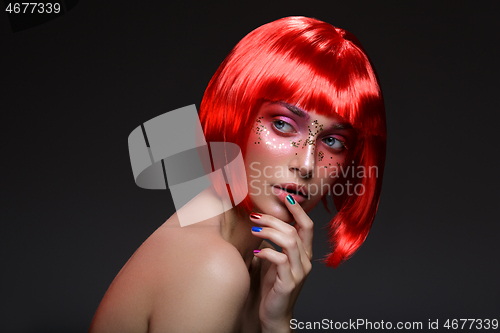 Image of Beautiful girl in red wig