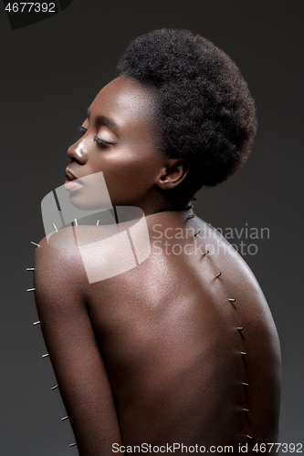 Image of Beautiful black girl with metal pins